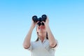 Businesswoman looking through binoculars outdoors Royalty Free Stock Photo