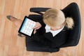 Businesswoman Looking At Calendar On Digital Tablet