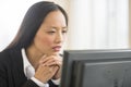 Businesswoman Looking At Computer In Office Royalty Free Stock Photo