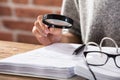 Businesswoman Looking At Document Through Magnifying Glass Royalty Free Stock Photo