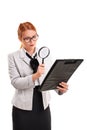 Businesswoman looking at document through magnifying glass Royalty Free Stock Photo