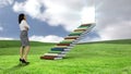 Businesswoman looking at stair made of books on a green commun ground