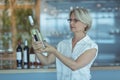 Businesswoman looking at winebottle Royalty Free Stock Photo