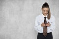 Businesswoman looks at something on the phone in full focus, cop