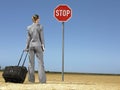 Businesswoman With Luggage Looking At Stop Sign Royalty Free Stock Photo