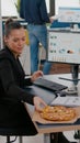 Businesswoman on lunch break at her table eating pizza fastfood delivery Royalty Free Stock Photo