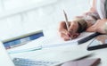 Hands of female financial manager taking notes when working on report. Businesswoman makes thoughts records at personal