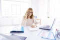 Businesswoman making a call while working on laptop in the office Royalty Free Stock Photo