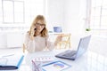 Businesswoman making a call while working on laptop in the office Royalty Free Stock Photo