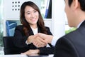 Businesswoman making handshake with a businessman