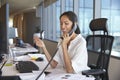 Businesswoman Making Phone Call Sitting At Desk In Office Royalty Free Stock Photo