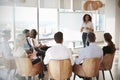 Businesswoman Making Presentation Shot Through Doorway Royalty Free Stock Photo