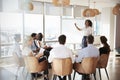 Businesswoman Making Presentation Shot Through Doorway Royalty Free Stock Photo