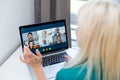 Businesswoman making video call to business partner using laptop. Close-up rear view of young woman having discussion Royalty Free Stock Photo