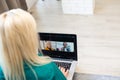 Businesswoman making video call to business partner using laptop. Close-up rear view of young woman having discussion Royalty Free Stock Photo