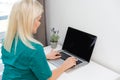 Businesswoman making video call to business partner using laptop. Close-up rear view of young woman having discussion Royalty Free Stock Photo