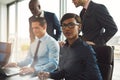 Businesswoman with male co-workers in office Royalty Free Stock Photo