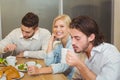 Businesswoman with male colleagues having snacks and coffee in canteen Royalty Free Stock Photo