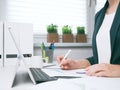 Businesswoman marks document with the marker. Businesswoman or entrepreneur in the home office. Online business, marketing or