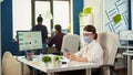 Businesswoman with mask chatting using phone in office room Royalty Free Stock Photo