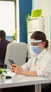 Businesswoman with mask chatting using phone in office room Royalty Free Stock Photo