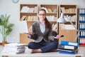 The businesswoman meditating in the office