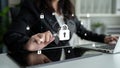 Businesswoman in Suit Securing Data Connection with Cybersecurity Icons on Tablet and Laptop in Modern Office Royalty Free Stock Photo