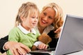 Businesswoman and mother showing kid the internet