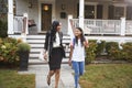 Businesswoman Mother Walking Daughter To School On Way To Work