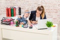 Businesswoman mother woman with a daughter working at the laptop