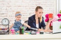 Businesswoman mother woman with a daughter working at the laptop