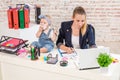 Businesswoman mother woman with a daughter working at the laptop