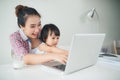 Businesswoman mother woman with a toddler working at the compute Royalty Free Stock Photo