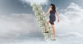 Businesswoman moving up on staircase made of money in sky Royalty Free Stock Photo