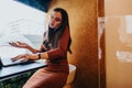 Businesswoman negotiating project with client in office phone booth while working on company growth.