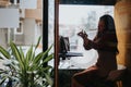 Successful Businesswoman Negotiating Project in Office Phone Booth