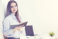 Businesswoman with notepad in sunlit office Royalty Free Stock Photo