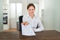 Businesswoman Offering Cheque In Office Royalty Free Stock Photo