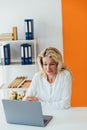 Business woman in office at laptop small business online