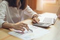 Businesswoman in office and use computer and calculator to perform financial accounting. Royalty Free Stock Photo