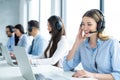 Businesswoman in an office, using laptop and wireless technology to communicate while listening and talking to client. Royalty Free Stock Photo