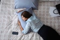 Exhausted businesswoman in office wear sleeping on bed at home after work, above view Royalty Free Stock Photo