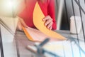 Businesswoman opening folder; multiple exposure