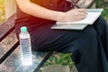 Businesswoman outdoor working with carry drinking water bottle