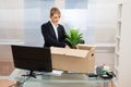 Businesswoman packing belongings in box Royalty Free Stock Photo