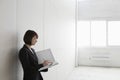 Businesswoman With Paperwork In Empty Warehouse Royalty Free Stock Photo