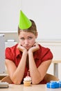 Businesswoman in party hat with birthday cupcake Royalty Free Stock Photo