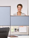 Businesswoman peering over cubicle wall Royalty Free Stock Photo