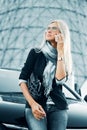 Fashion business woman calling on cell phone by her car Royalty Free Stock Photo