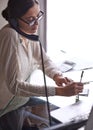 Businesswoman, phone call and notes, office and desk or conversation with client. Technology, computer and writing Royalty Free Stock Photo